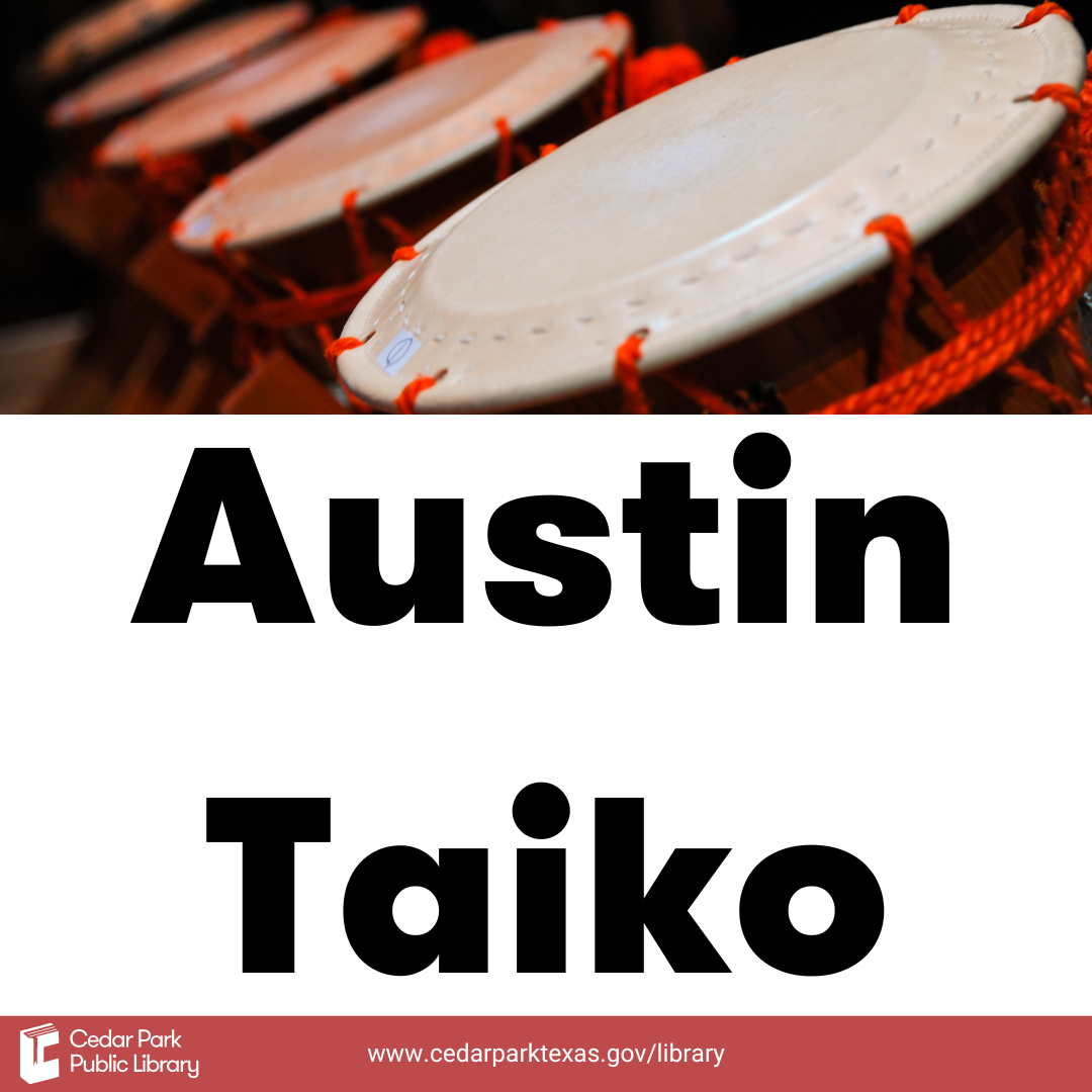 Grouping of drums with white top and orange body with text reading Austin Taiko.